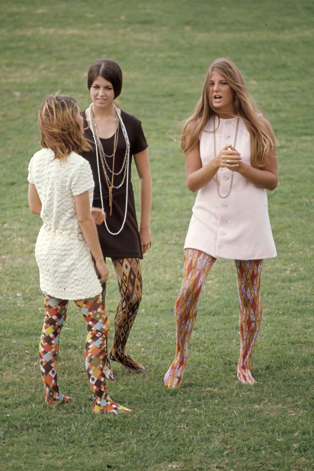 Subject:  Right to left: Kim RObertson, Pat Auvenshine and Pam Pepin wearing hippy fashion which inculdes Pucci tights and simple dresses. Corona del Mar High. California October 1969 Photographer- Arthur Schatz Time Inc Owned merlin- 1201940