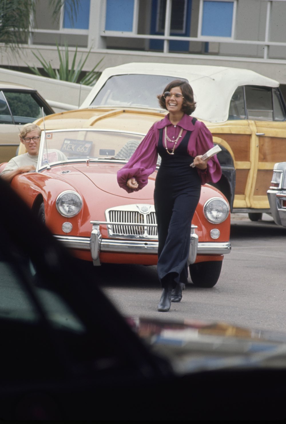 Subject: High schooler Lenore Reday stops traffic while wearing bell bottomed jump suit.  Newport Beach, California October 1969 Photographer- Arthur Schatz Time Inc Owned Merlin- 1201942